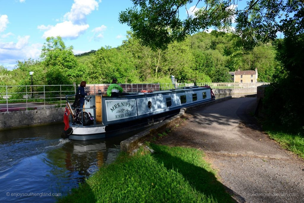 Narrow Boat entering the Avoncliff Aqueduct in Wiltshire after a sharp right angle bend